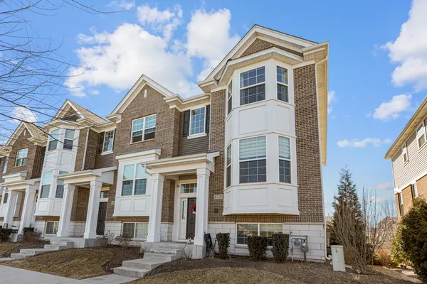 a front view of a residential apartment building with a yard