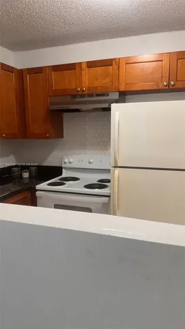 a kitchen with a sink and a refrigerator