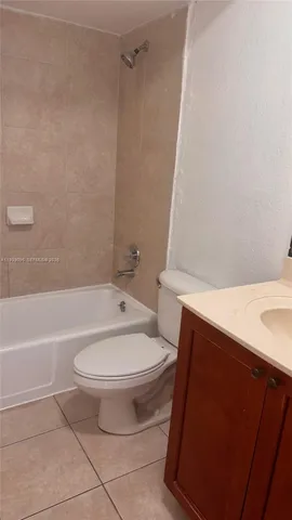 a white toilet sitting next to a bath tub