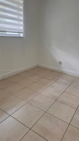 an empty room with a bench and cabinet