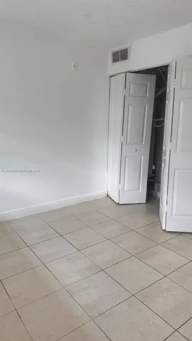 a kitchen with appliances a sink and cabinets
