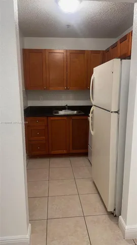 a kitchen with a refrigerator and a cabinets