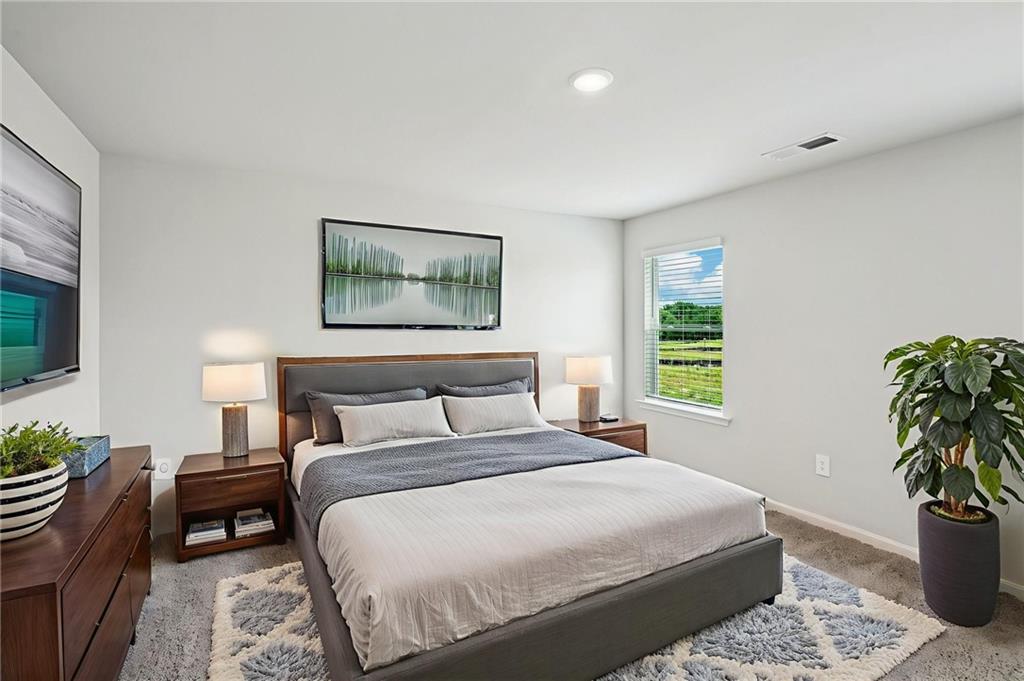 2034 Avalon Ridge Conyers, GA 30013 - Photo 27 of 35 a bedroom with a bed and a potted plant