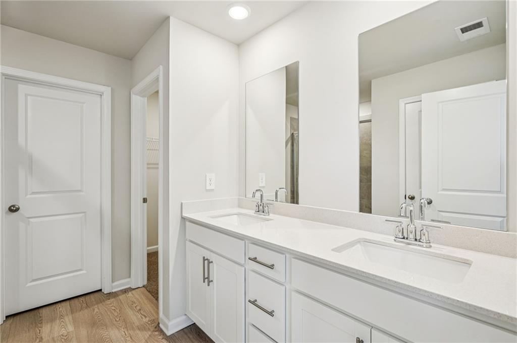 2034 Avalon Ridge Conyers, GA 30013 - Photo 29 of 35 a bathroom with a double vanity sink and a mirror