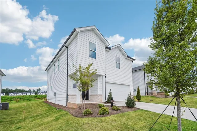 a front view of a house with a yard