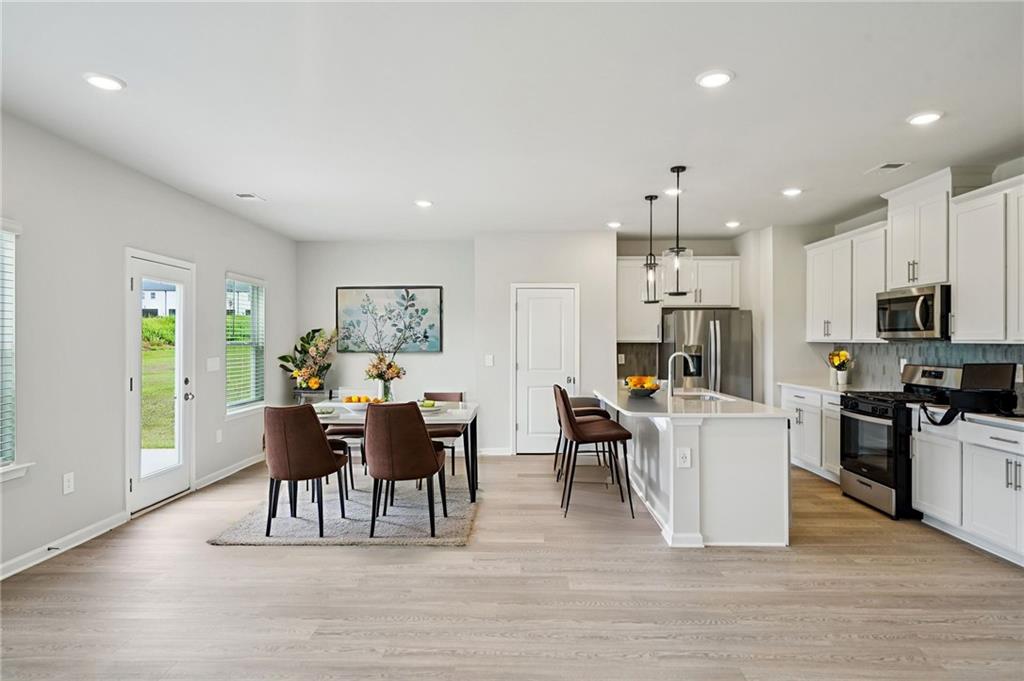 2034 Avalon Ridge Conyers, GA 30013 - Photo 5 of 35 a view of a dining room with furniture window and wooden floor