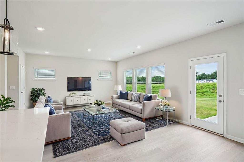 2034 Avalon Ridge Conyers, GA 30013 - Photo 9 of 35 a living room with furniture and a flat screen tv