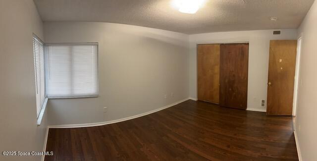 800 North Fiske Boulevard, Unit 114 Cocoa, FL 32922 - Photo 14 of 17 an empty room with wooden floor and windows