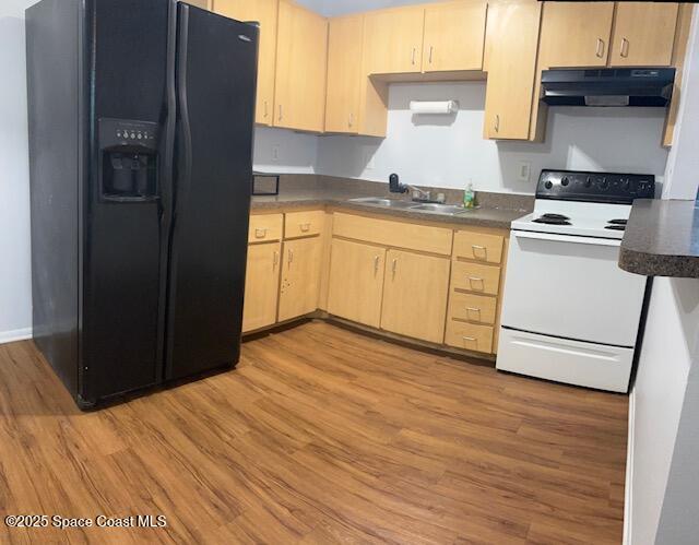 800 North Fiske Boulevard, Unit 114 Cocoa, FL 32922 - Photo 2 of 17 a kitchen with a stove cabinets and wooden floor
