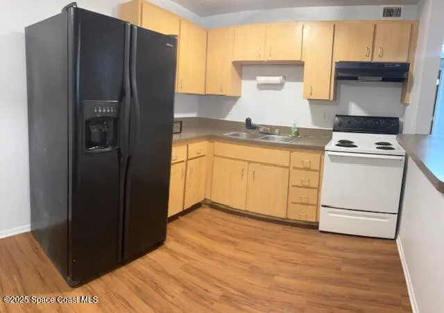 a kitchen with a refrigerator and cabinets