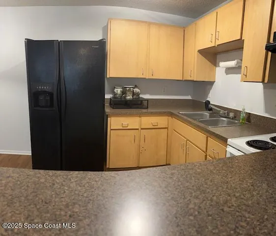 a kitchen with a sink and a refrigerator