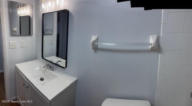 800 North Fiske Boulevard, Unit 114 Cocoa, FL 32922 - Photo 7 of 17 a bathroom with a sink a toilet and mirror