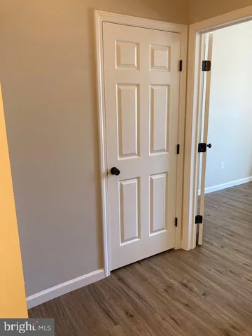 a view of front door with wooden floor
