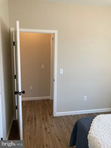 view of a bedroom with wooden floor