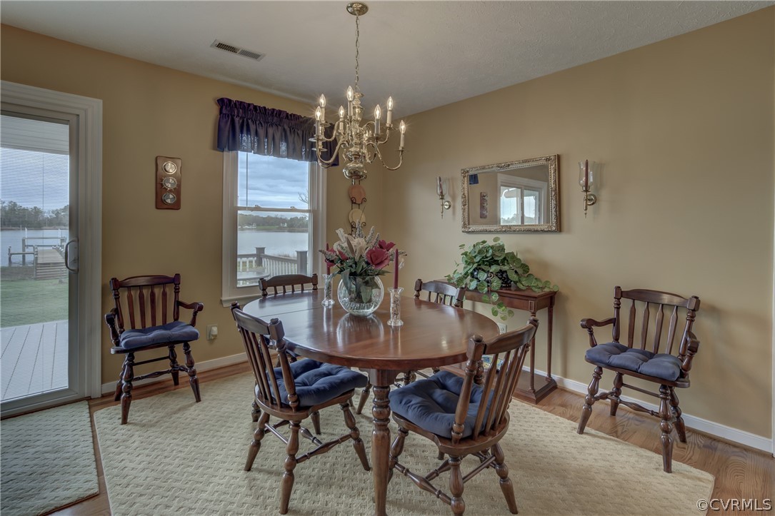 531 Indian Banks Road Farnham, VA 22460 - Photo 16 of 34 a view of a dining room with furniture a chandelier and wooden floor
