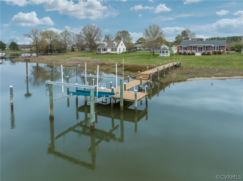 531 Indian Banks Road Farnham, VA 22460 - Photo 4 of 34 a view of a lake with a bench in front of house