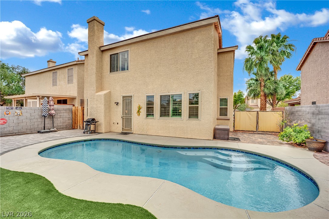 1724 Millstream Way Henderson, NV 89074 - Photo 37 of 60 A private backyard oasis with a refreshing pool, ideal for relaxation and entertaining.