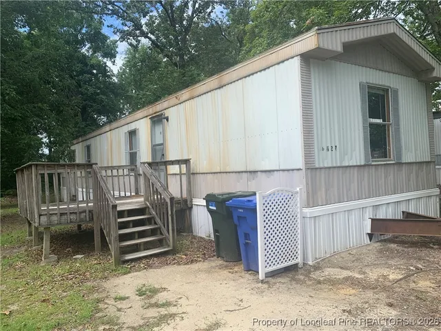 a backyard of a house with wooden floor and fence