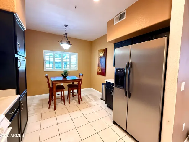 a kitchen with stainless steel appliances granite countertop a refrigerator and a stove top oven