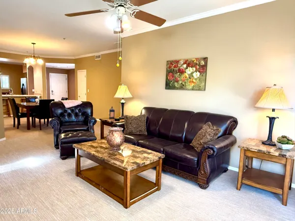 a living room with furniture a dining table and a lamp