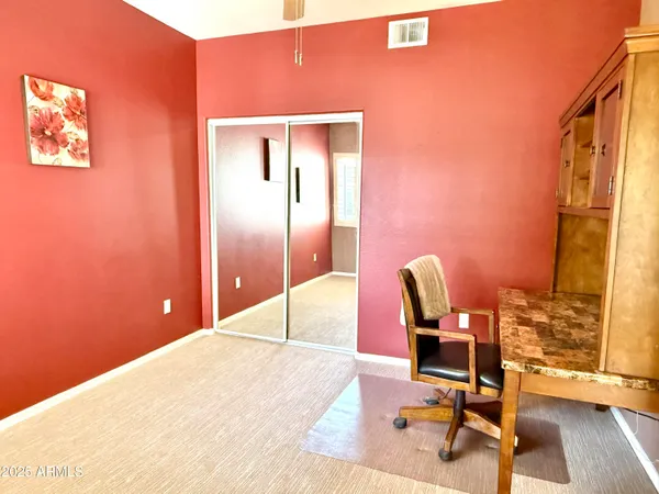 a bedroom with a bed a desk and chair