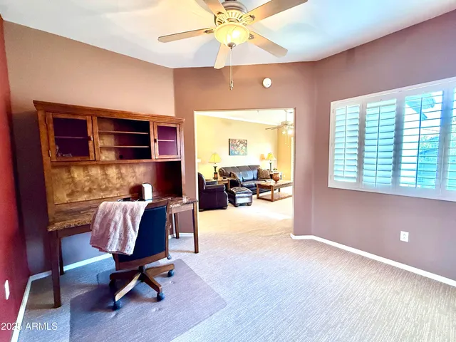 a livingroom with furniture a flat screen tv and a large window