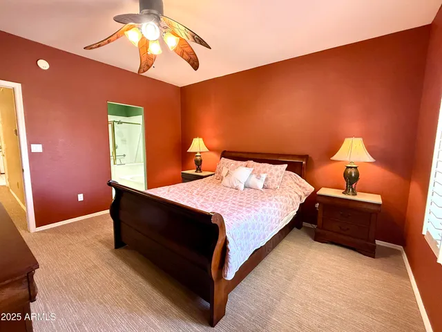 a spacious bedroom with a bed and a chandelier