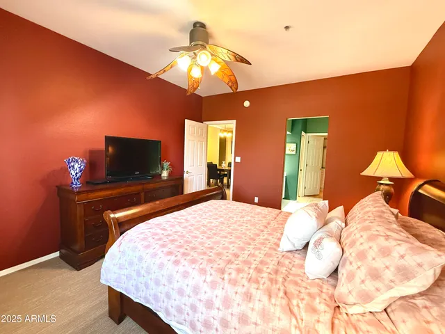 a bedroom with a bed and a flat screen tv