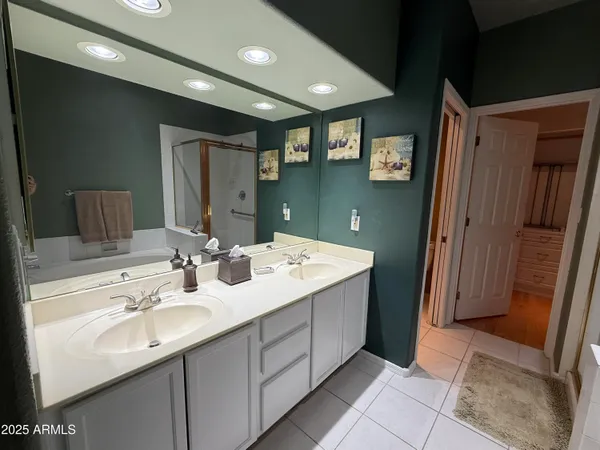 a bathroom with a double vanity sink and mirror