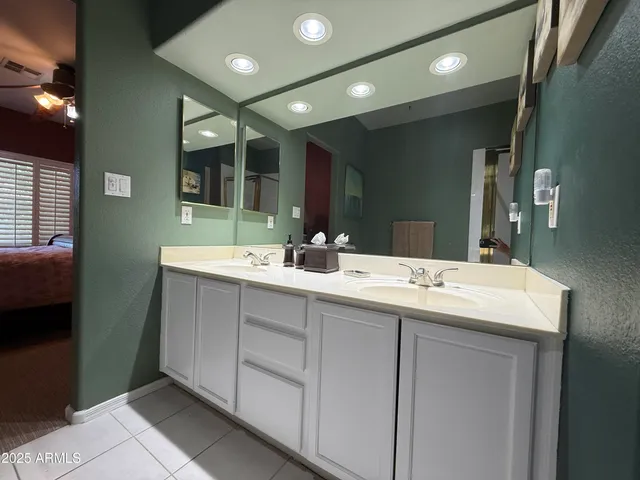 a bathroom with a double vanity sink and a mirror