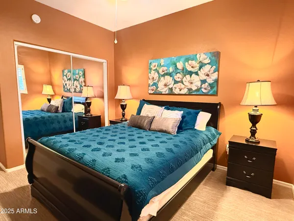 a bed sitting in a bedroom next to a window