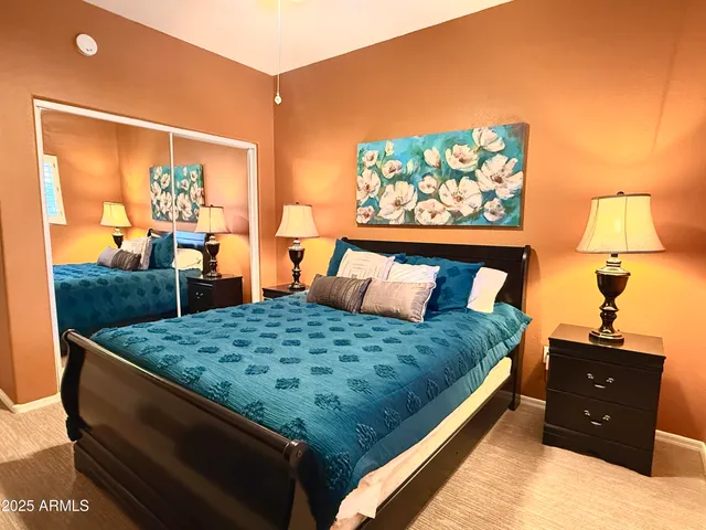 a bed sitting in a bedroom next to a window