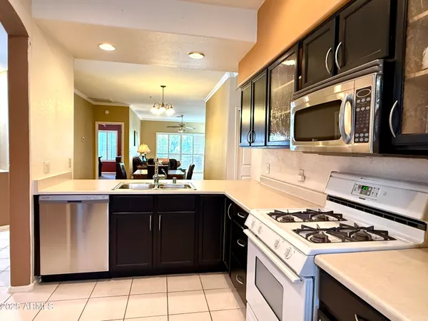 a kitchen with a sink a stove and cabinets