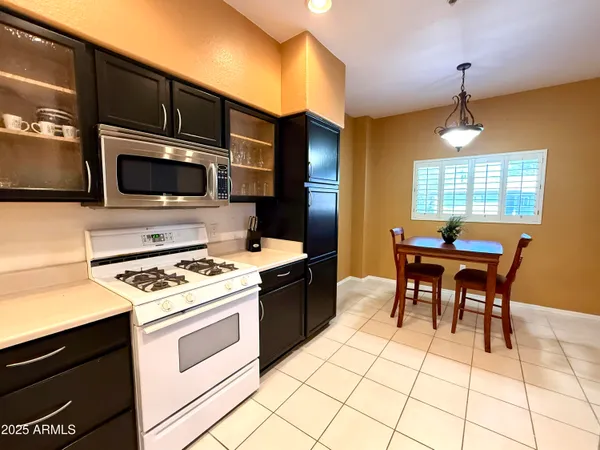 a kitchen with a stove a sink and a microwave