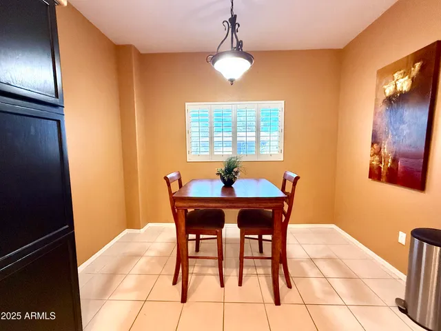 a dining room with furniture and window