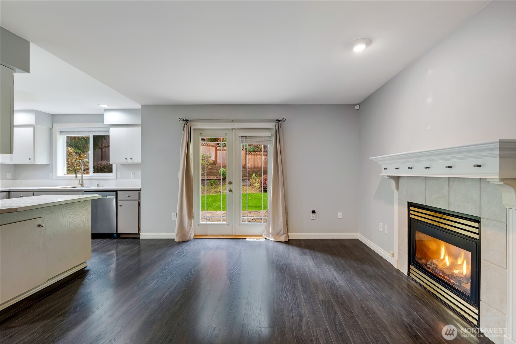 15606 Cascadian Way Bothell, WA 98012 - Photo 11 of 36 a view of empty room with a fireplace and wooden floor