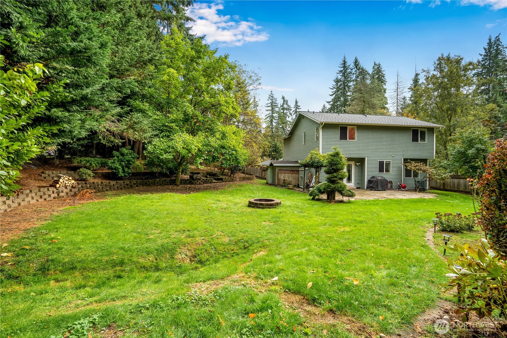 15606 Cascadian Way Bothell, WA 98012 - Photo 29 of 36 a view of a house with backyard sitting area and garden