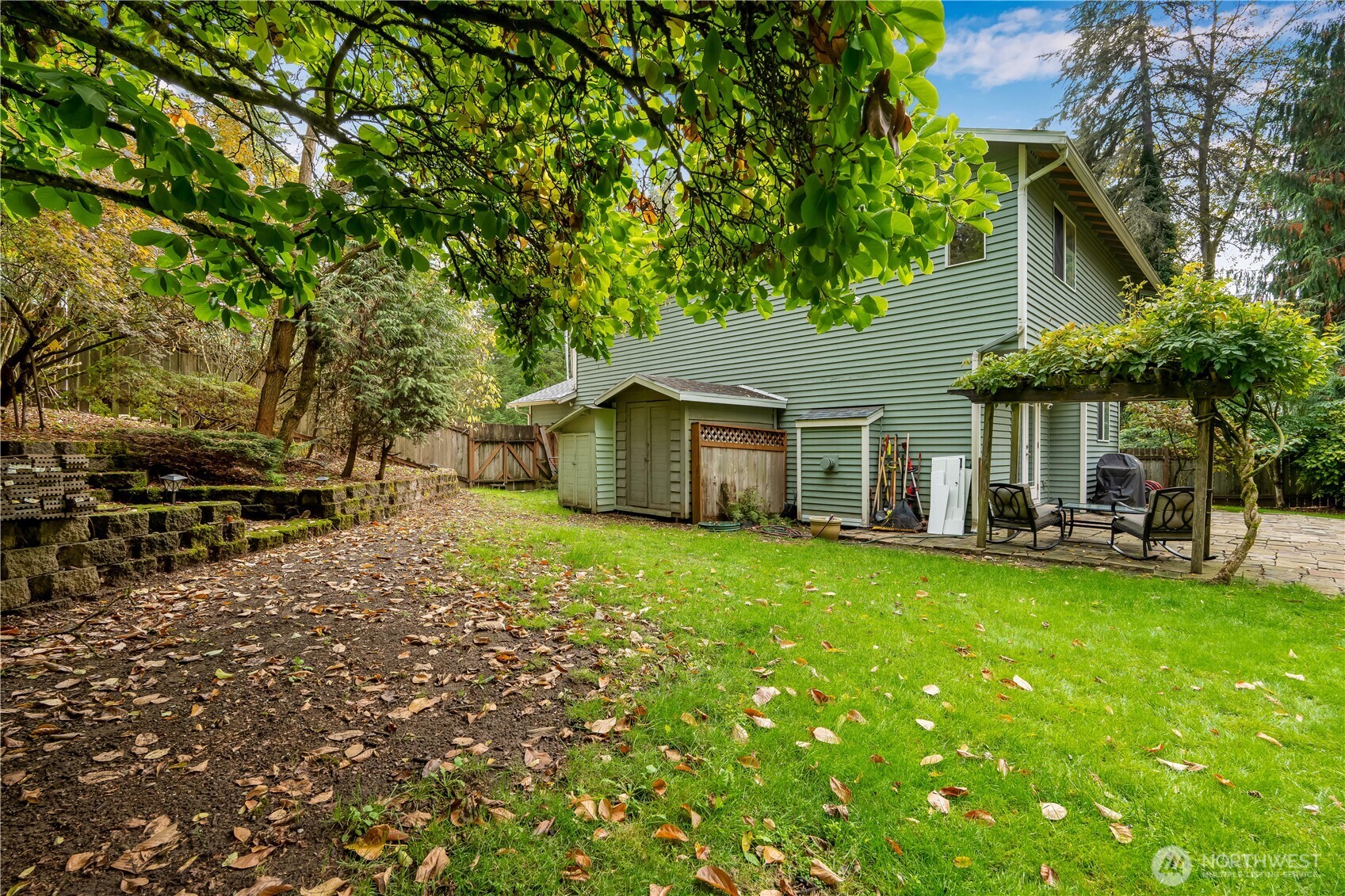 15606 Cascadian Way Bothell, WA 98012 - Photo 31 of 36 a backyard of a house with table and chairs under an umbrella