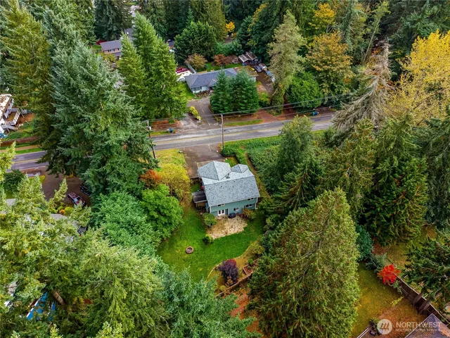 an aerial view of a house with a yard