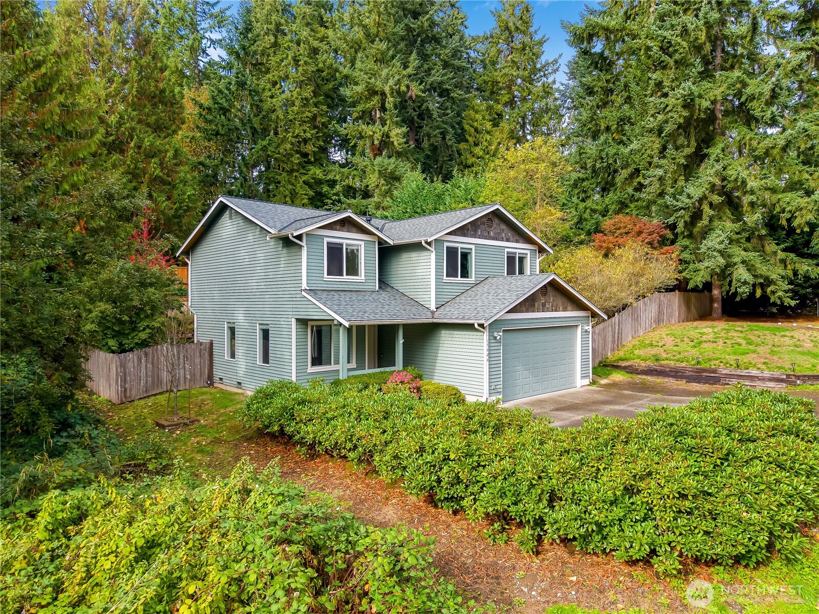 15606 Cascadian Way Bothell, WA 98012 - Photo 35 of 36 a front view of a house with a yard and trees