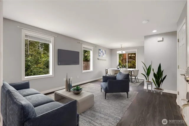 a living room with furniture and a potted plant