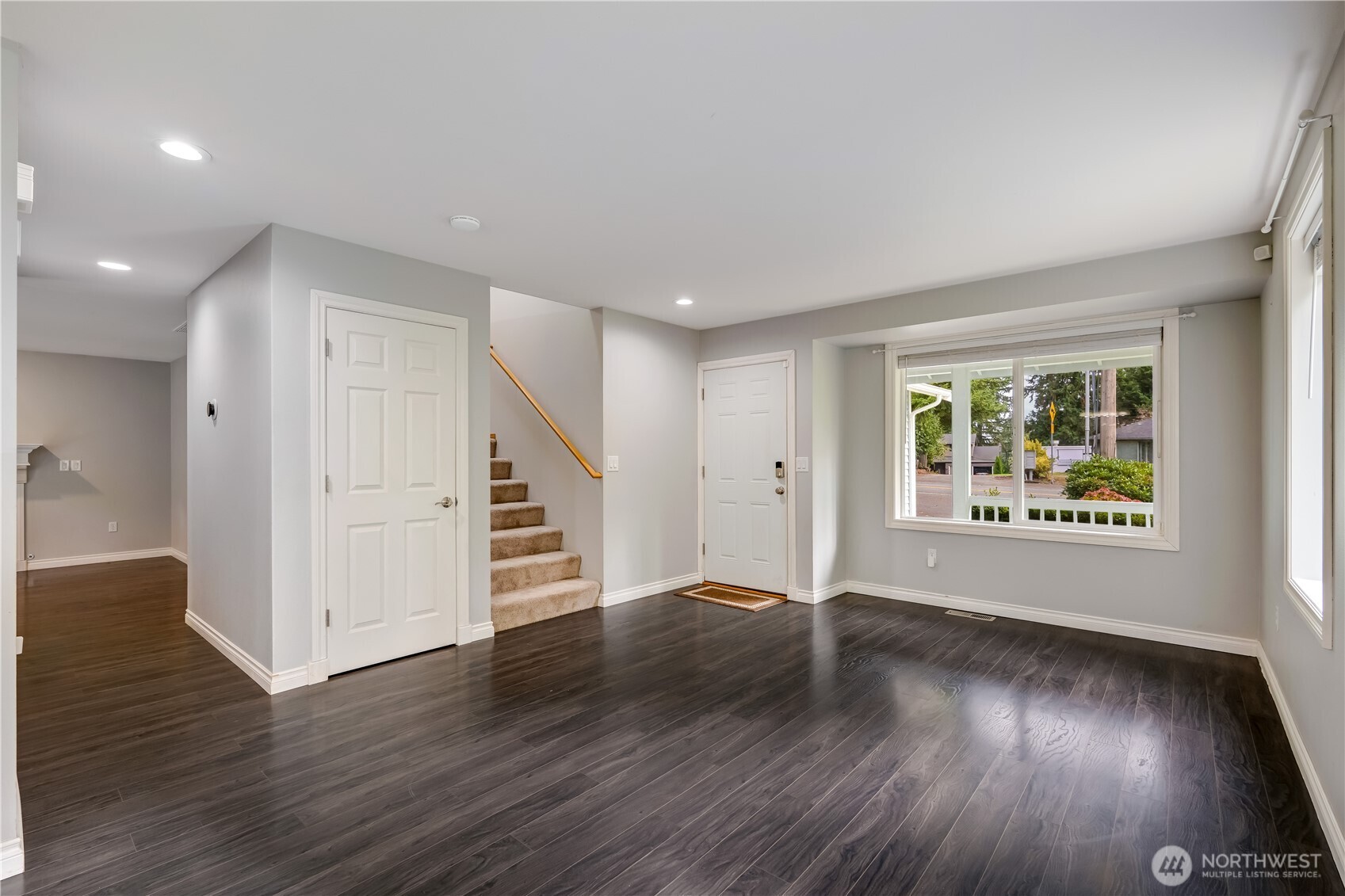 15606 Cascadian Way Bothell, WA 98012 - Photo 6 of 36 a view of an empty room with wooden floor and a window