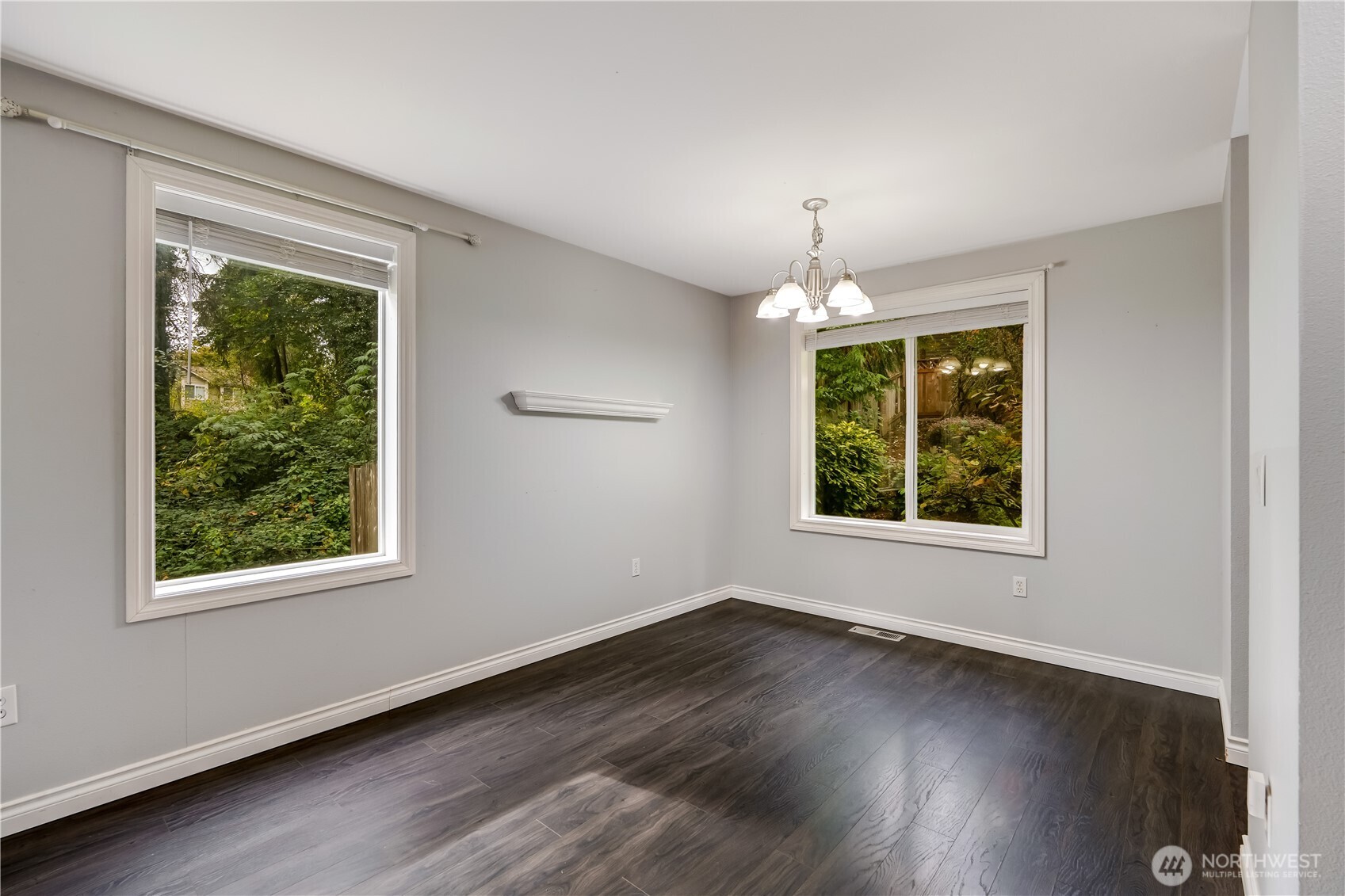 15606 Cascadian Way Bothell, WA 98012 - Photo 7 of 36 a view of an empty room with wooden floor and a window