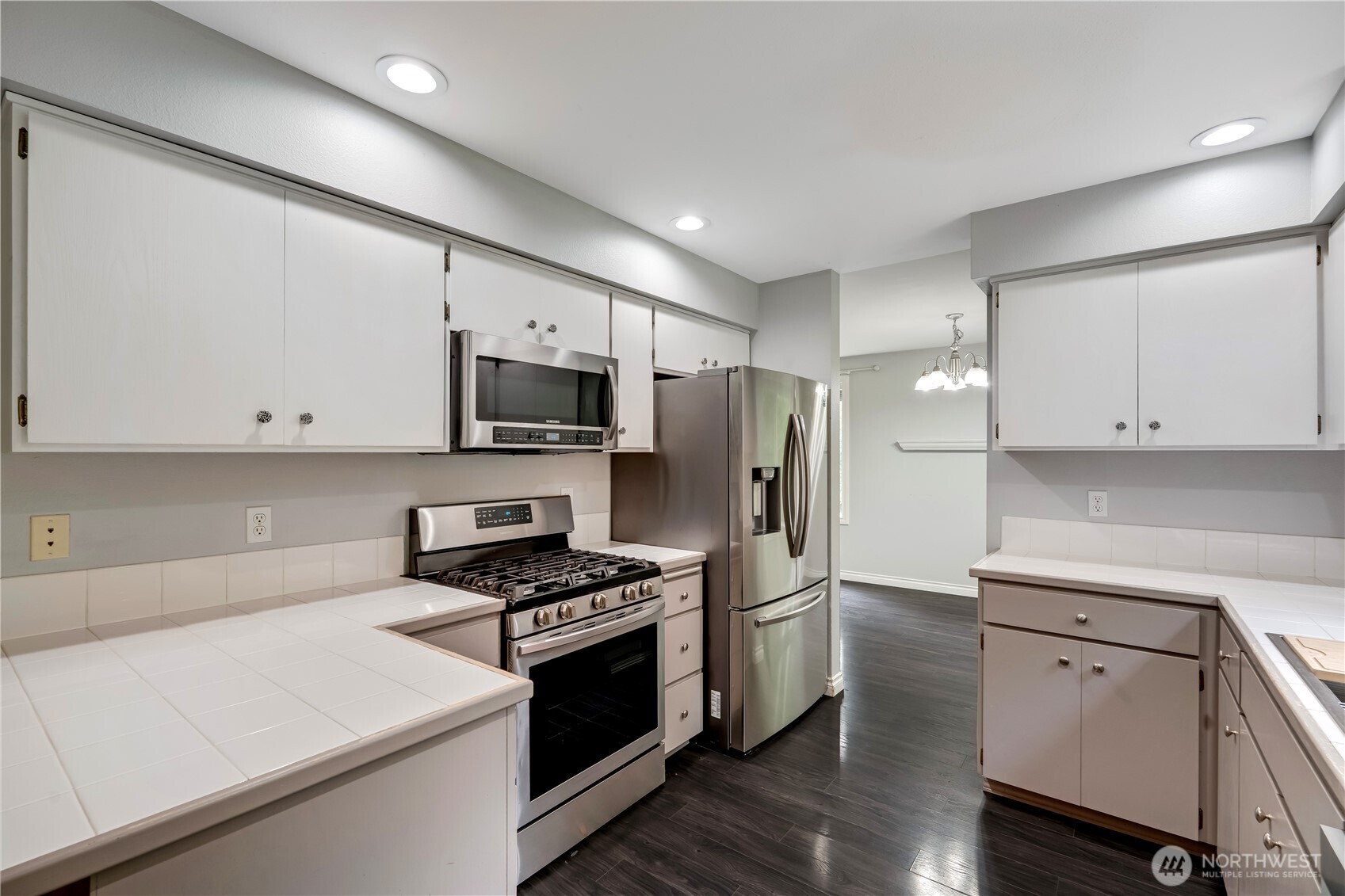 15606 Cascadian Way Bothell, WA 98012 - Photo 8 of 36 a kitchen with stainless steel appliances a refrigerator stove and microwave