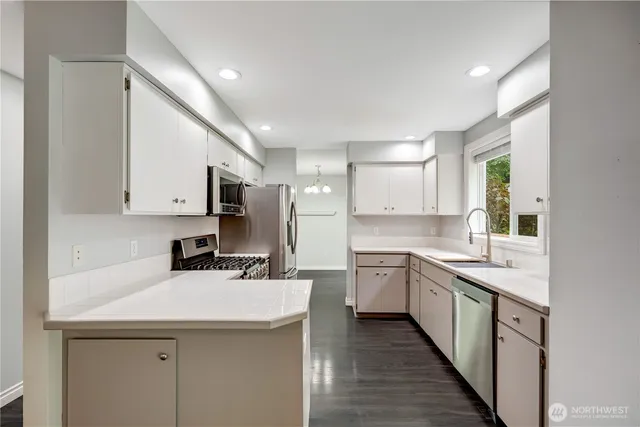 a kitchen with a sink stove and cabinets