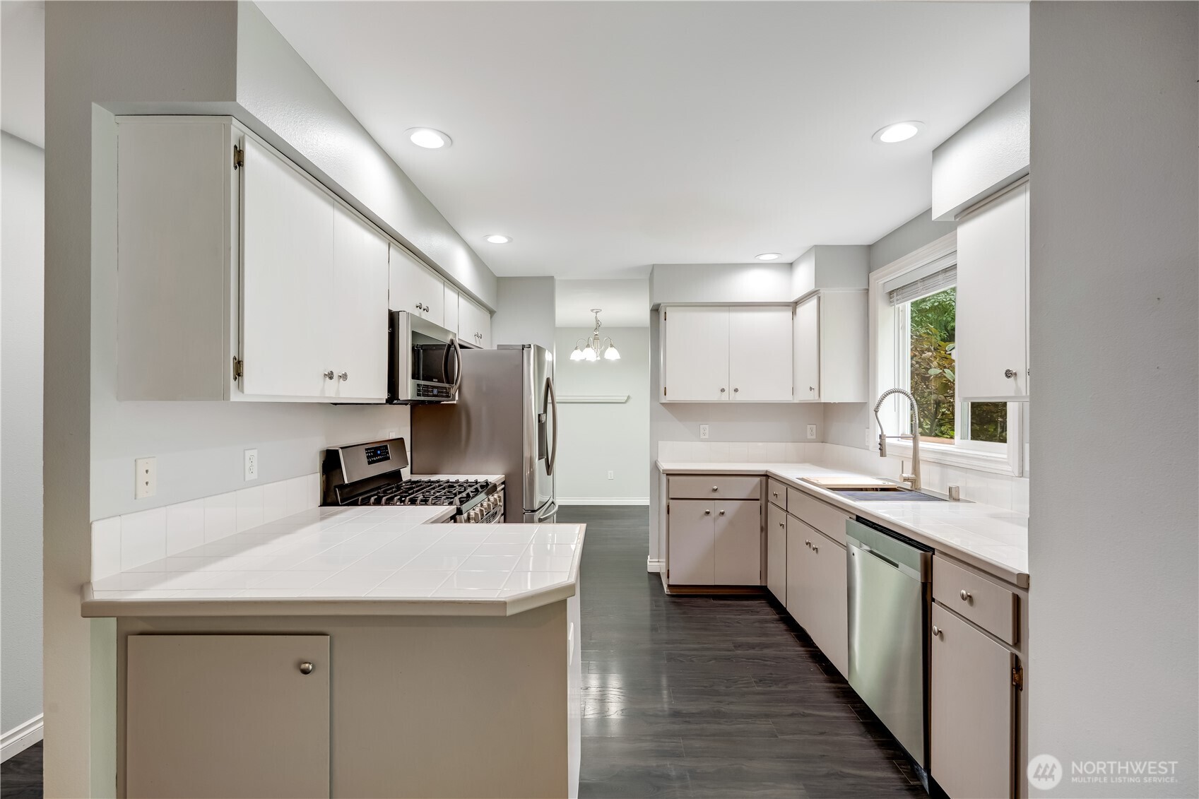 15606 Cascadian Way Bothell, WA 98012 - Photo 9 of 36 a kitchen with a sink stove and cabinets