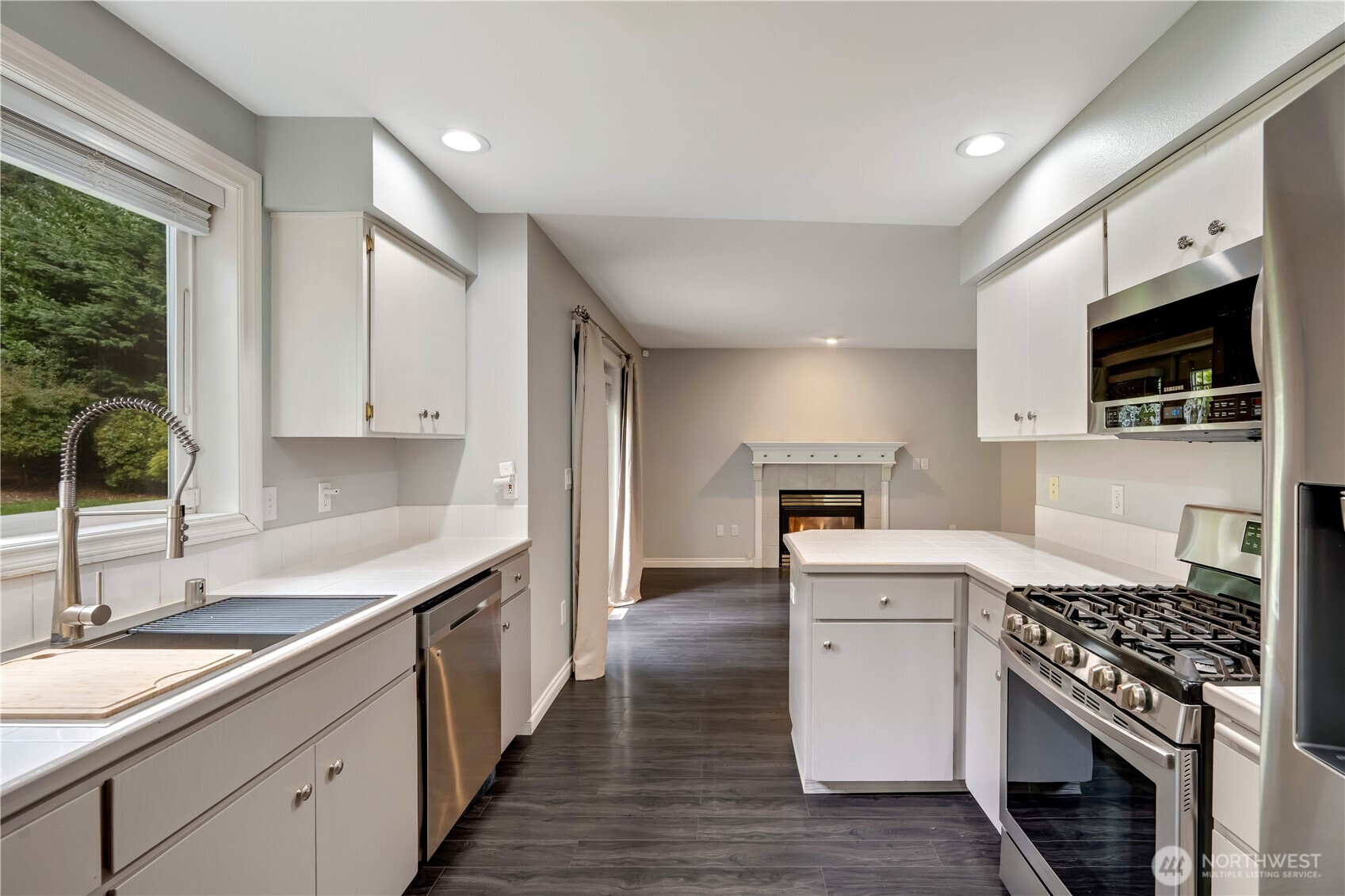 15606 Cascadian Way Bothell, WA 98012 - Photo 10 of 36 a kitchen with granite countertop a sink stove and cabinets