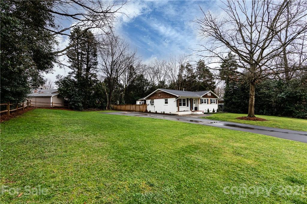 1417 Burnley Road Charlotte, NC 28210 - Photo 2 of 43 a view of a house with a big yard plants and large trees