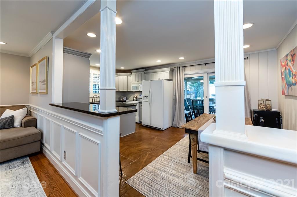 1417 Burnley Road Charlotte, NC 28210 - Photo 11 of 43 a kitchen with stainless steel appliances kitchen island granite countertop a refrigerator and a stove