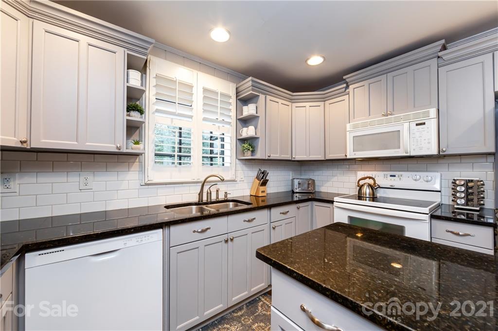 1417 Burnley Road Charlotte, NC 28210 - Photo 19 of 43 a kitchen with stainless steel appliances granite countertop a sink a stove and cabinets